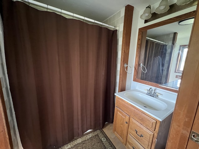 bathroom featuring vanity and a shower with shower curtain