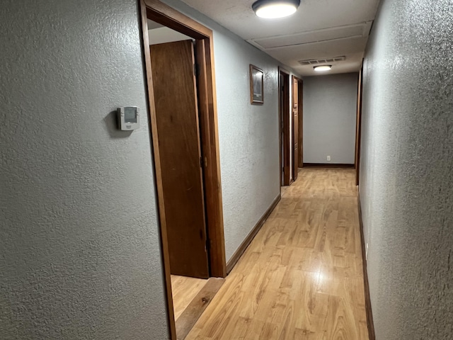 hall with light hardwood / wood-style floors