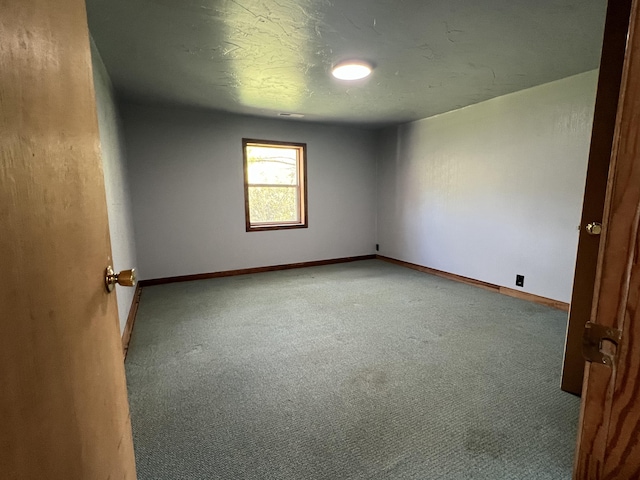 carpeted spare room featuring a textured ceiling