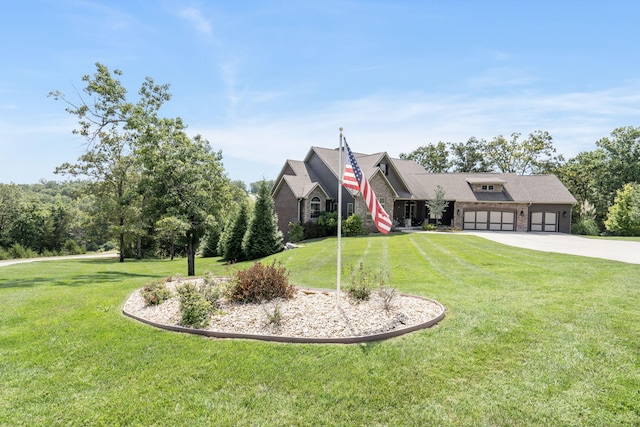 view of front of property with a garage and a front lawn