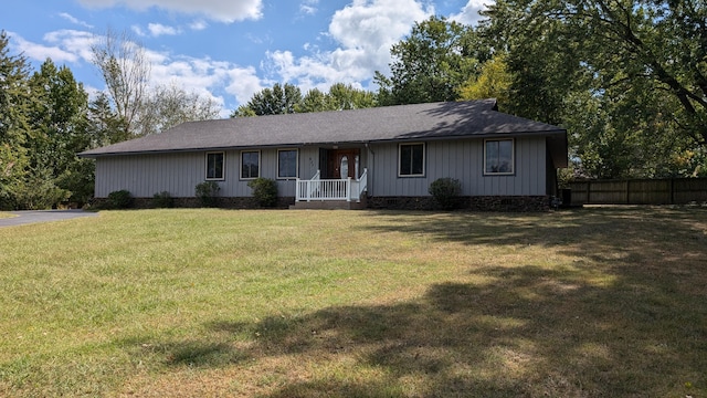single story home with a front lawn, fence, and roof with shingles