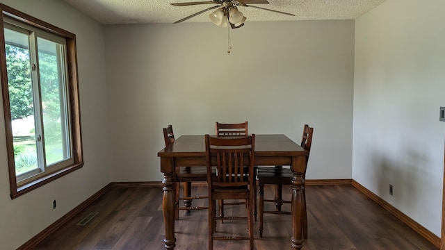 dining area featuring ceiling fan, a textured ceiling, and dark wood-type flooring