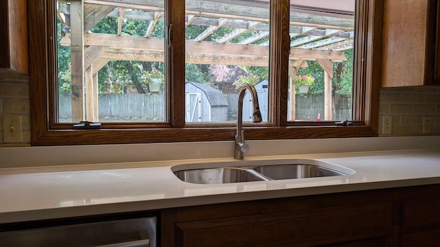 interior details featuring wine cooler, backsplash, and sink