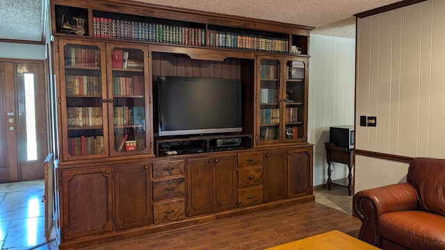living area featuring a textured ceiling and ornamental molding