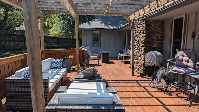 view of patio featuring a pergola, an outdoor living space, a deck, and fence