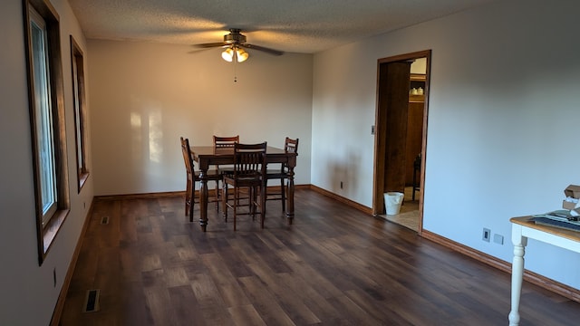 dining room with ceiling fan, a textured ceiling, and dark hardwood / wood-style floors