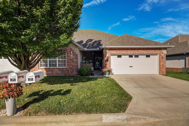 view of front of property featuring a front yard and a garage