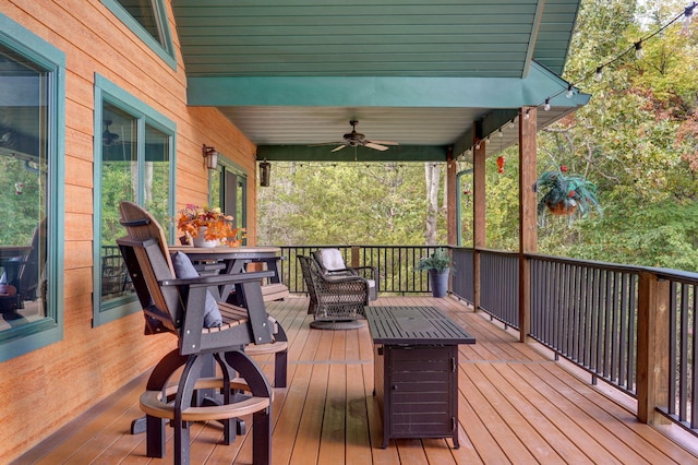 wooden terrace featuring ceiling fan