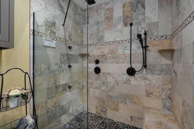 bathroom with a tile shower