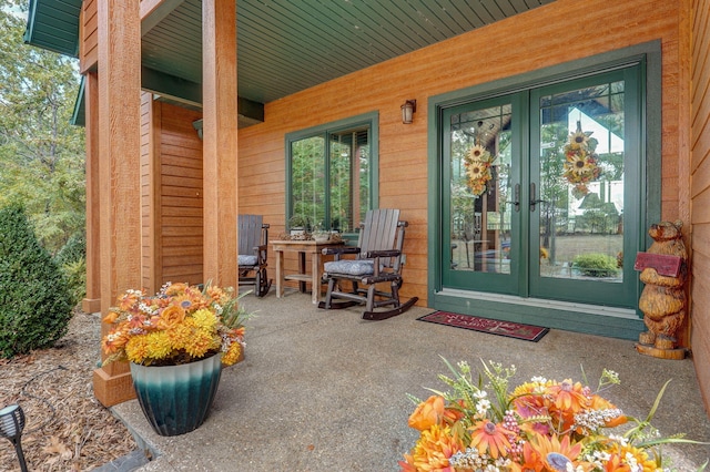 view of exterior entry featuring french doors and a patio