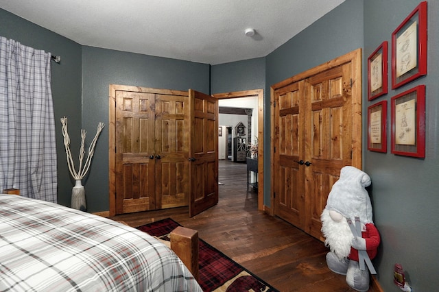 bedroom with a closet, dark hardwood / wood-style floors, and a textured ceiling