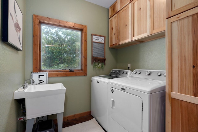 washroom featuring washer and dryer and cabinets