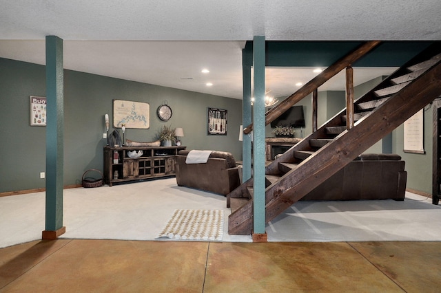 stairway featuring a textured ceiling and concrete floors