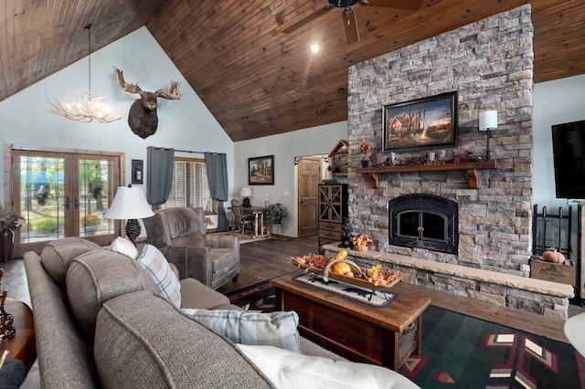 living room featuring a stone fireplace, wood ceiling, hardwood / wood-style floors, and high vaulted ceiling