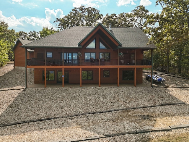 back of property featuring a balcony