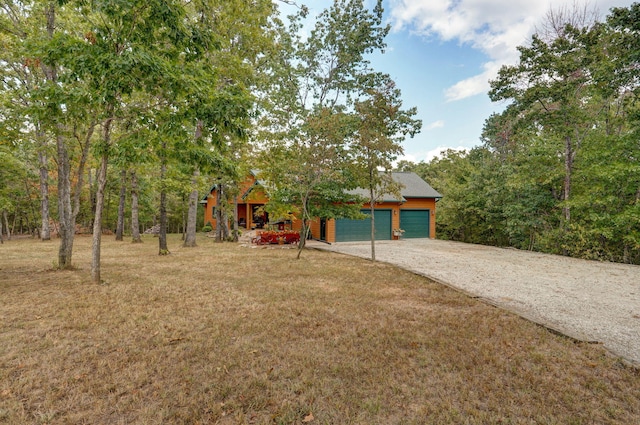 view of front of property with a front yard and a garage