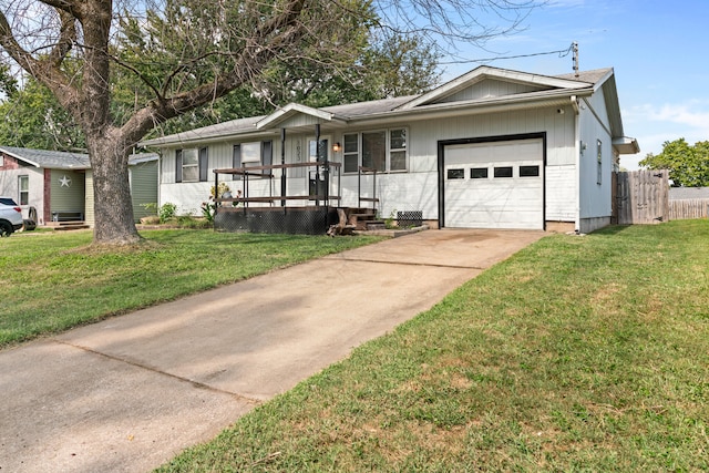 ranch-style home with covered porch, a front yard, and a garage