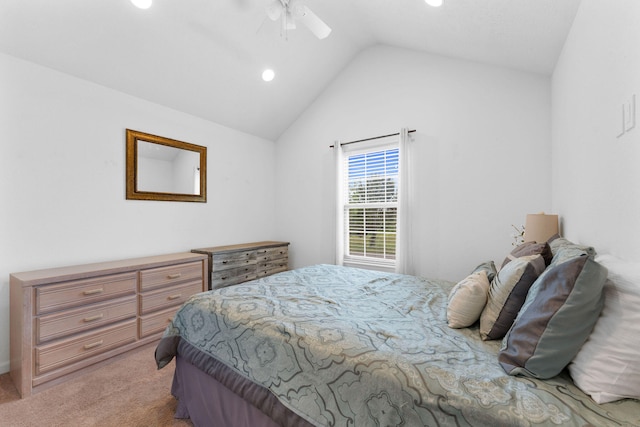 bedroom with light colored carpet, vaulted ceiling, and ceiling fan