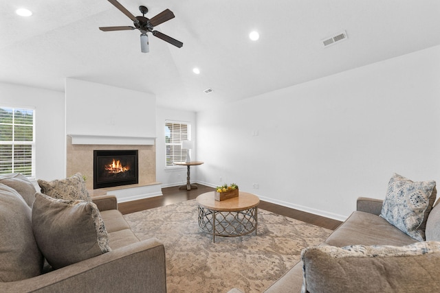 living room with ceiling fan, vaulted ceiling, and wood-type flooring