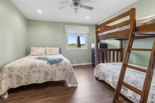 bedroom with dark hardwood / wood-style floors and ceiling fan