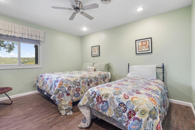 bedroom with dark hardwood / wood-style floors and ceiling fan