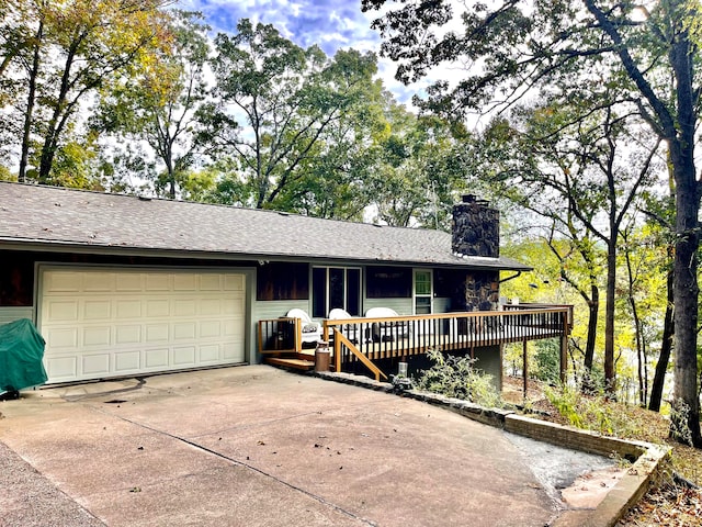 single story home featuring a garage and a deck