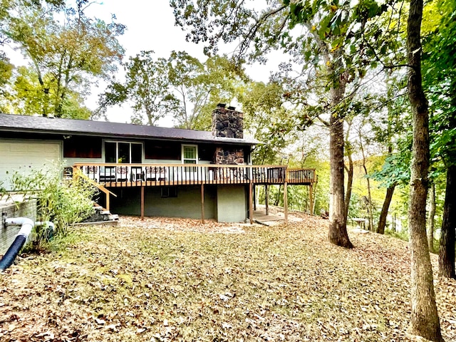 back of property featuring a wooden deck