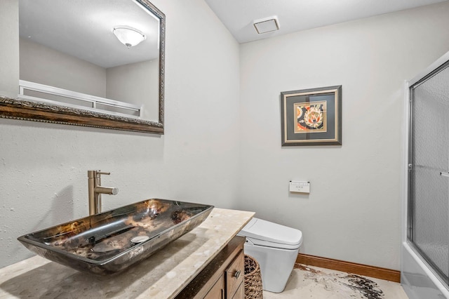 bathroom featuring toilet, vanity, and tile patterned floors