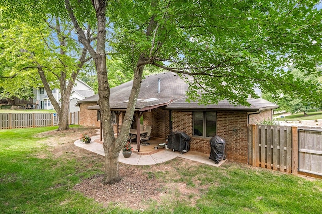 back of property with a patio area and a yard