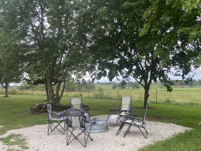 exterior space with a fire pit and a rural view