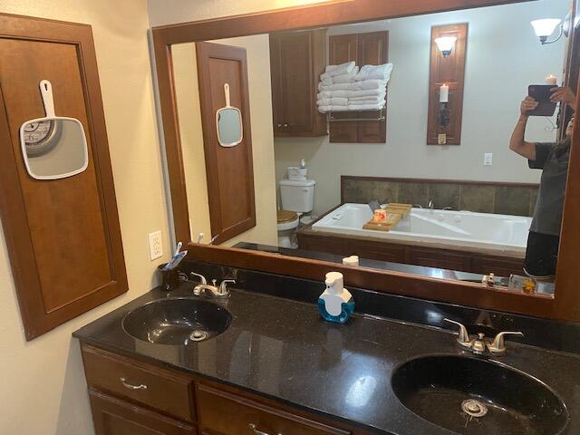 bathroom featuring a tub to relax in and vanity