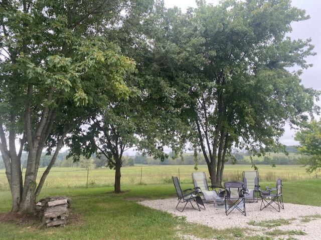 view of yard with a rural view and a patio