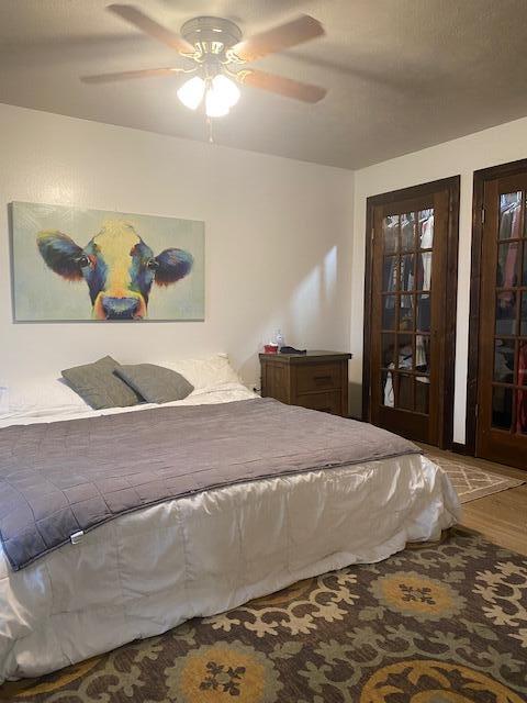 bedroom featuring ceiling fan and hardwood / wood-style floors