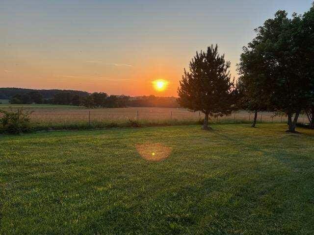 yard at dusk with a rural view