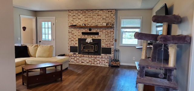 living room with dark hardwood / wood-style floors and a wood stove