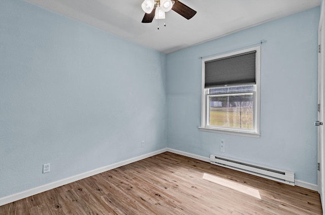 empty room with ceiling fan, a baseboard radiator, and light hardwood / wood-style floors