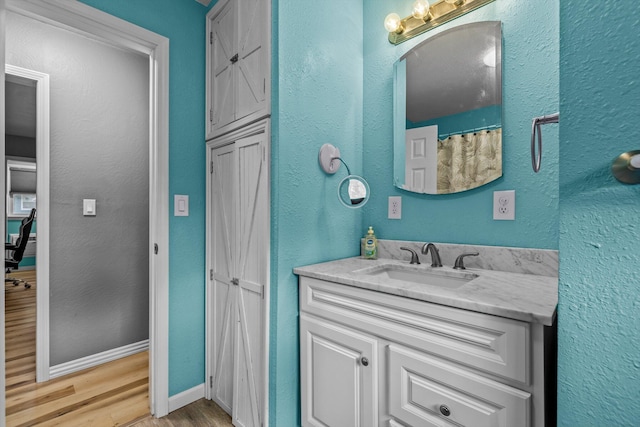 bathroom with vanity and hardwood / wood-style floors