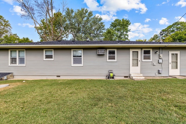 back of property featuring a lawn