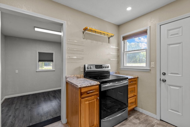 kitchen featuring stainless steel range with electric cooktop and light wood-type flooring