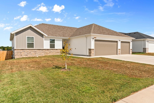 view of front of home featuring a front yard and a garage