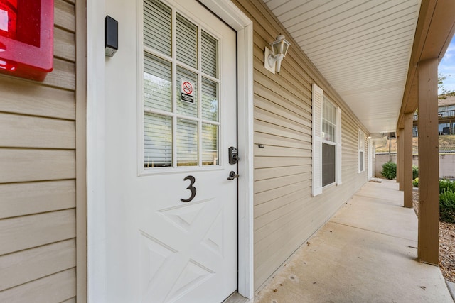 view of exterior entry with a porch