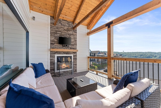 exterior space with an outdoor living space with a fireplace and a wooden deck