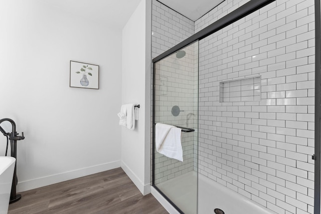 bathroom with wood-type flooring and an enclosed shower