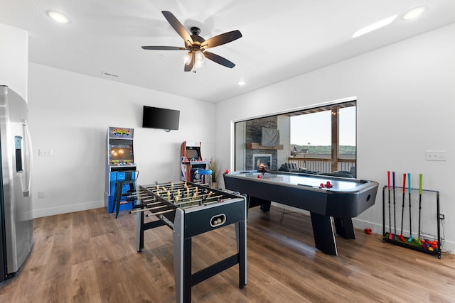 rec room with ceiling fan and wood-type flooring