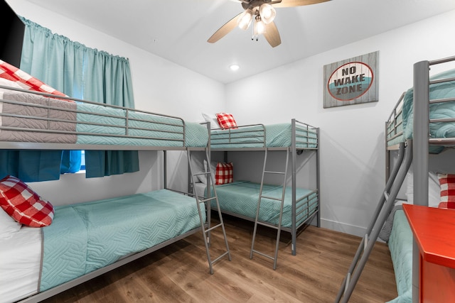 bedroom featuring wood-type flooring and ceiling fan