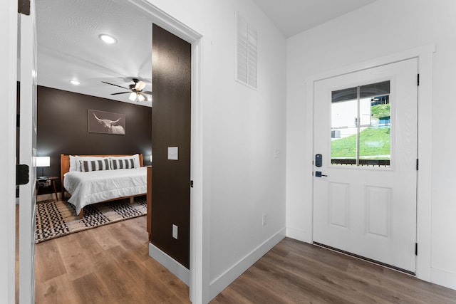 interior space with wood-type flooring, a textured ceiling, and ceiling fan