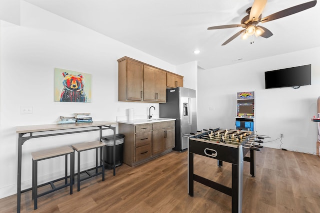 recreation room with ceiling fan, dark wood-type flooring, and sink