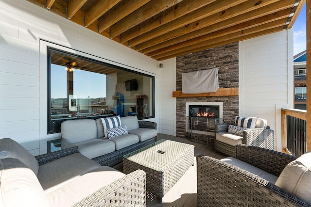 view of patio with an outdoor living space with a fireplace