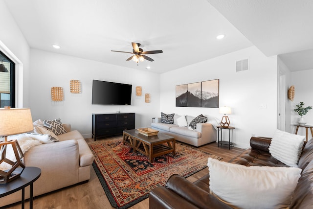 living room featuring ceiling fan and hardwood / wood-style floors