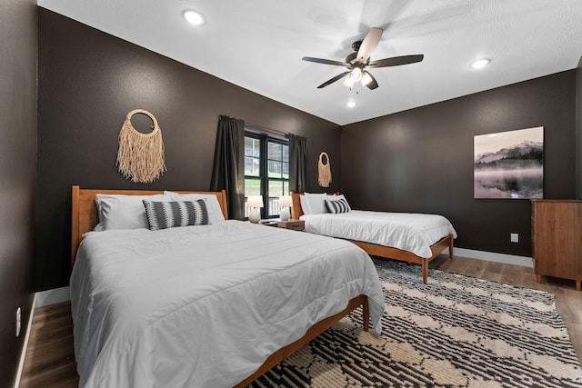 bedroom featuring hardwood / wood-style floors and ceiling fan